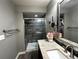 Modern bathroom featuring a glass-enclosed shower and granite vanity at 9377 Longstone Dr, Parker, CO 80134
