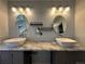 Bathroom featuring double sinks, marble countertops, and modern lighting at 9377 Longstone Dr, Parker, CO 80134