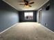 Neutral bedroom featuring plush carpet, a ceiling fan, and large window allowing for ample light at 9377 Longstone Dr, Parker, CO 80134