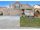 Charming two-story home featuring a three-car garage, landscaped yard, and well-maintained lawn at 9377 Longstone Dr, Parker, CO 80134
