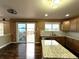 Spacious kitchen featuring a large island, hardwood floors, and a view of the backyard deck at 9377 Longstone Dr, Parker, CO 80134