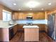 Modern kitchen boasts stainless steel appliances, granite countertops, and a functional center island at 9377 Longstone Dr, Parker, CO 80134