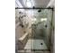 Walk-in shower featuring marble tiles, a built-in bench, and modern fixtures in a neutral color palette at 9377 Longstone Dr, Parker, CO 80134
