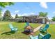 Lovely backyard features a fire pit, patio with seating, and expansive lawn, perfect for outdoor gatherings at 8333 Depew Way, Arvada, CO 80003