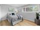 Cozy bedroom with two windows, neutral colors, and a comfortable single bed at 8333 Depew Way, Arvada, CO 80003