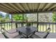 Relaxing deck features a dining table and chairs, perfect for enjoying the tranquil scenery of the landscaped yard at 8333 Depew Way, Arvada, CO 80003