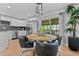 Bright dining area adjacent to kitchen boasts sliding doors, stylish lighting, and seating for four at 8333 Depew Way, Arvada, CO 80003