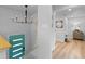 Entryway with a modern chandelier, vibrant blue door and access to the second floor at 8333 Depew Way, Arvada, CO 80003