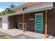 Close up of a brick home featuring a teal-colored front door with modern design details at 8333 Depew Way, Arvada, CO 80003