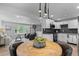 Open concept eat-in kitchen with modern lighting adjacent to a living area at 8333 Depew Way, Arvada, CO 80003