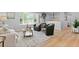 Bright living room featuring a large window, modern furnishings, and beautiful hardwood floors at 8333 Depew Way, Arvada, CO 80003