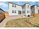 Backyard view of a modern two-story home with gray siding, a small lawn, and a gravel area for landscaping at 27798 E 7Th Pl, Aurora, CO 80018