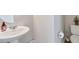 Simple and clean half bathroom with a pedestal sink and neutral decor at 27798 E 7Th Pl, Aurora, CO 80018