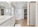 This large bathroom has double sinks, a glass door shower, and a walk-in linen closet at 27798 E 7Th Pl, Aurora, CO 80018