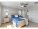 Bedroom with hardwood floors, ceiling fan, blue bedding, multiple windows and an ensuite bathroom at 27798 E 7Th Pl, Aurora, CO 80018