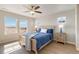 Bedroom with hardwood floors, ceiling fan, blue bedding, multiple windows and views at 27798 E 7Th Pl, Aurora, CO 80018