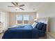 Bedroom with hardwood floors, ceiling fan, blue bedding, multiple windows and views at 27798 E 7Th Pl, Aurora, CO 80018