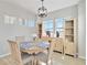 Bright dining area features a round table, modern light fixtures, and beautiful built in shelving at 27798 E 7Th Pl, Aurora, CO 80018