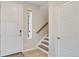 Bright entryway featuring a staircase, wood floors, and a freshly painted front door at 27798 E 7Th Pl, Aurora, CO 80018