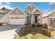 Charming two-story home featuring a well-manicured lawn, a cozy front porch and a two car garage at 27798 E 7Th Pl, Aurora, CO 80018