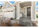 Close-up of a charming front porch with decorative flower boxes, a welcoming wreath, and neutral paint at 27798 E 7Th Pl, Aurora, CO 80018