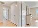 Hallway with closet space leading into a room with white dresser and mirror at 27798 E 7Th Pl, Aurora, CO 80018