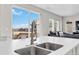 Stylish kitchen island with stainless steel sink and faucet overlooking a stunning view at 27798 E 7Th Pl, Aurora, CO 80018