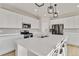 Modern kitchen featuring white cabinets, stainless steel appliances, and a spacious center island at 27798 E 7Th Pl, Aurora, CO 80018