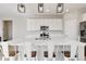 Open kitchen with a large island, stainless steel appliances, and modern pendant lighting at 27798 E 7Th Pl, Aurora, CO 80018