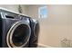 The laundry room features a modern washer and dryer with dark, metal accents at 27798 E 7Th Pl, Aurora, CO 80018