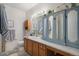 Classic bathroom featuring a wood vanity, neutral walls, and an oversized mirror at 2896 W Riverwalk Cir # A214, Littleton, CO 80123