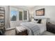 Comfortable bedroom with a cozy bed, natural light, and calming decor at 2896 W Riverwalk Cir # A214, Littleton, CO 80123