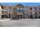 Attractive brick condo building with covered entrance and well-maintained landscaping and parking at 2896 W Riverwalk Cir # A214, Littleton, CO 80123