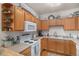 Well-lit kitchen featuring wooden cabinets, modern appliances, and efficient layout at 2896 W Riverwalk Cir # A214, Littleton, CO 80123