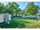 Spacious backyard featuring a storage shed, privacy fence, green lawn, and mature trees at 2814 S Winona Ct, Denver, CO 80236