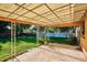 Covered backyard patio with decorative ironwork providing shade over a large concrete slab at 2814 S Winona Ct, Denver, CO 80236