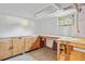 Unfinished basement offering workspace and storage, featuring sturdy wooden workbenches and cabinets at 2814 S Winona Ct, Denver, CO 80236
