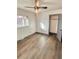 Bedroom features wood flooring, a closet, neutral walls, and a large window for natural light at 2814 S Winona Ct, Denver, CO 80236