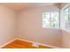 Cozy bedroom with natural light streaming through the window and hardwood floors at 1170 Kingston St, Aurora, CO 80010
