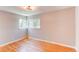 Comfortable bedroom featuring ample natural light, hardwood floors, and modern light fixture at 1170 Kingston St, Aurora, CO 80010
