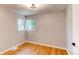 Well-lit bedroom with hardwood floors and a large window offering a view at 1170 Kingston St, Aurora, CO 80010