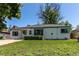 Exterior view of the house with a green lawn at 1170 Kingston St, Aurora, CO 80010
