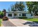 Charming single-story home featuring a well-maintained front yard and a long driveway at 1170 Kingston St, Aurora, CO 80010