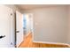Bright hallway featuring freshly painted walls, gleaming hardwood floors, and modern white doors at 1170 Kingston St, Aurora, CO 80010