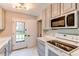 Well-lit kitchen featuring modern appliances, stylish countertops, and ample cabinet space at 1170 Kingston St, Aurora, CO 80010