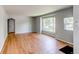 Living room features a light grey color scheme, wood floors, and dual windows for ample natural light at 1170 Kingston St, Aurora, CO 80010