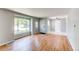 Bright living room with hardwood floors, large window, and fresh paint throughout at 1170 Kingston St, Aurora, CO 80010