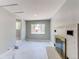 Open living room featuring marble floors, wainscotting, a brick fireplace, and a bright window at 1170 Kingston St, Aurora, CO 80010