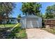 The backyard features a detached garage and a large grassy area at 1170 Kingston St, Aurora, CO 80010