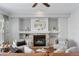 Living room with a stone fireplace and a large circular mirror above the mantle at 14075 W Amherst Ave, Lakewood, CO 80228